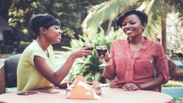 two girls drinking wine